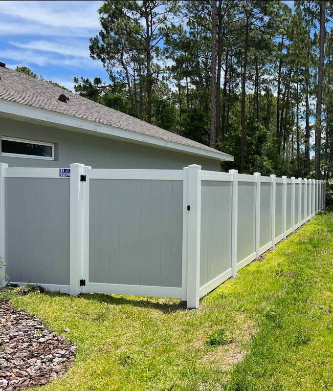 White vinyl privacy fence with gate installed by Lex Fencing