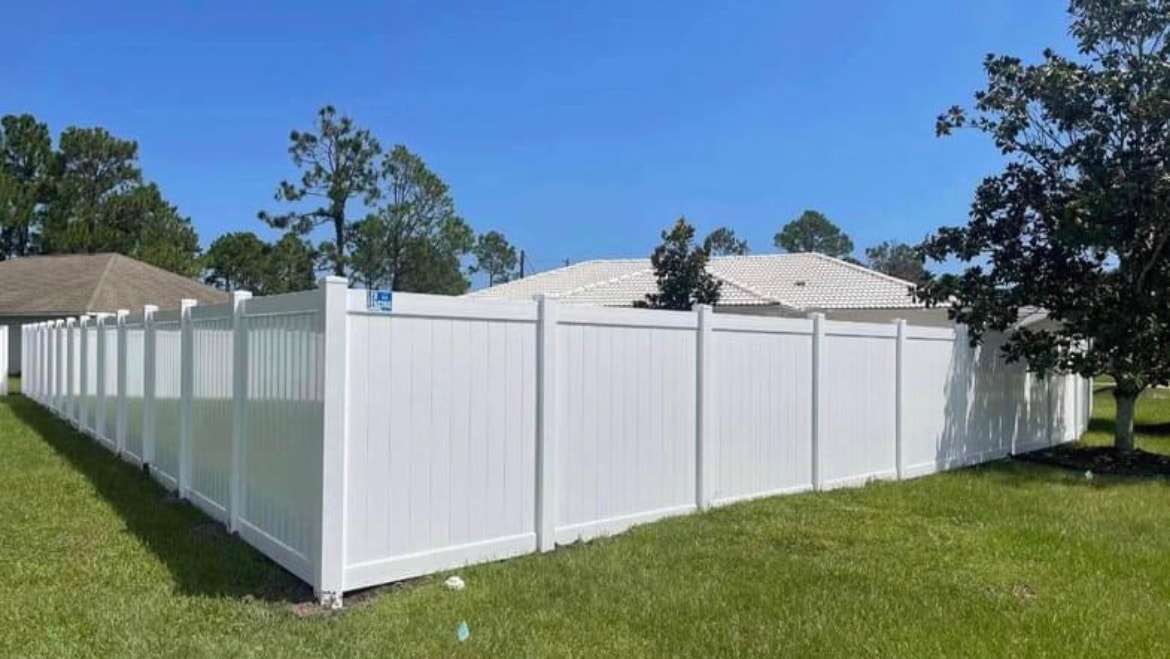 White vinyl privacy fence installed by Lex Fencing in a sunny Palm Coast backyard